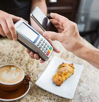 Phone being placed over Point of Sale Terminal