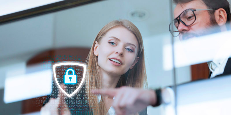 Business man and woman pointing to a lock and shield superimpossed over the image