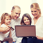 Family looking at a laptop